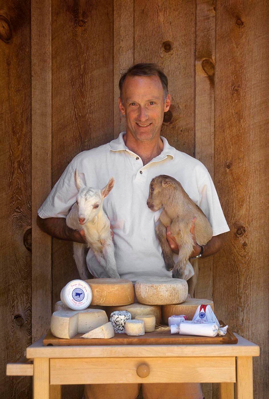 OWNER PIERRE KOLISCH displays a variety of the GOAT CHEESES he produced at JUNIPER GROVE FARM in REDMOND OREGON. - Photography by Eagle Visions Photography