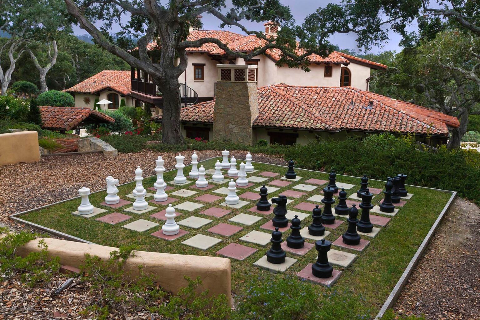 A giant chess set on the grounds of a California Spanish style home. - Architecture photography by Eagle Visions Photography