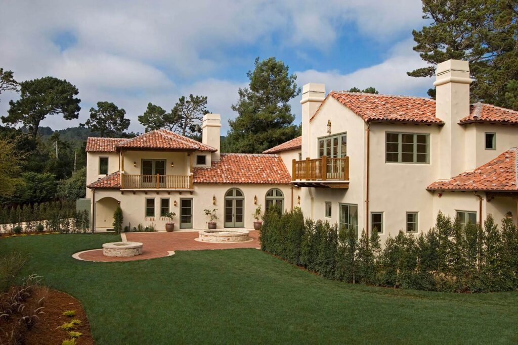 Exterior of a SPANISH STYLE LUXURY HOME with stucco walls and red tile roof in Pebble Beach California. -  Architecture photography by Eagle Visions Photography
