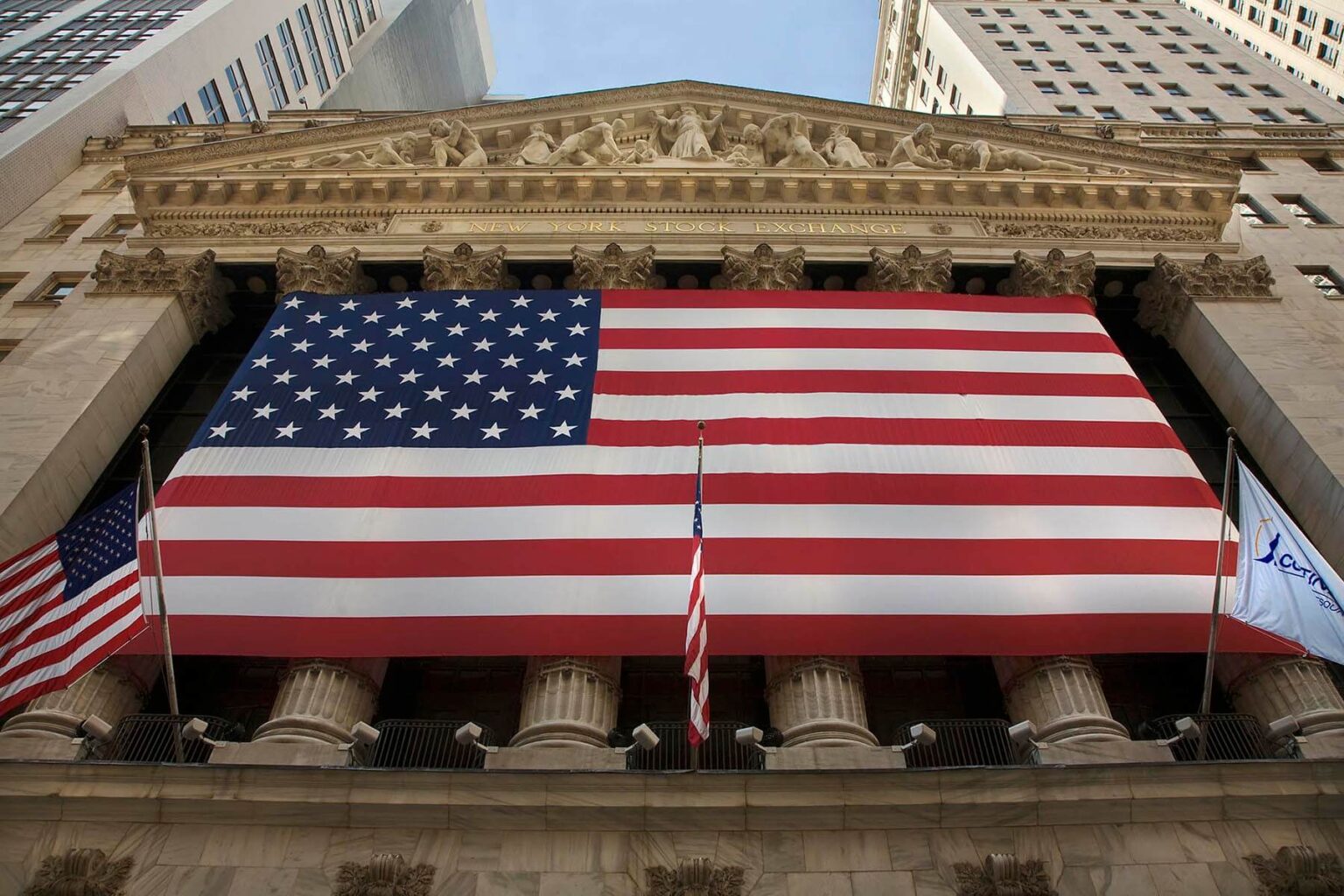 Large AMERICAN FLAG in front of the New Your Stock Exchange in NEW YORK CITY. - Architecture photography by Eagle Visions Photography