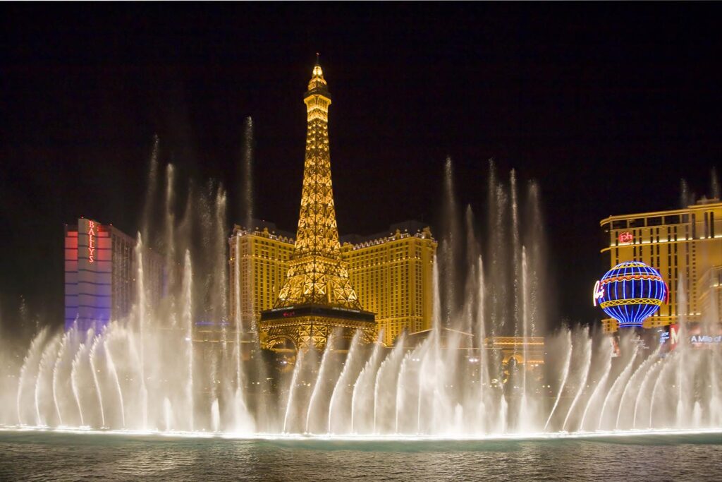 The evening FOUNTAIN SHOW at the BELLAGIO looking towards the PARIS HOTEL AND CASINO in LAS VEGAS NEVADA. - Architecture photography by Eagle Visions Photography