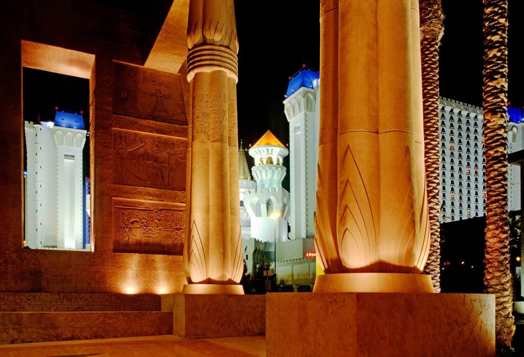 EXCALIBUR HOTEL and GAMBLING CASINO is seen through the columns of the LUXOR PYRAMID in LAS VEGAS, NEVADA. - Architecture photography by Eagle Visions Photography