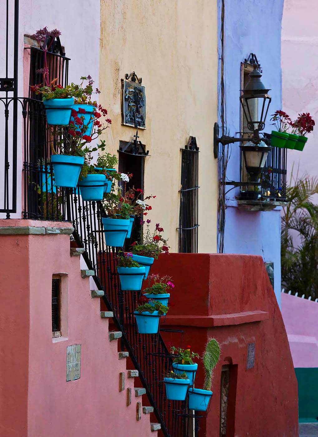 BLUE FLOWER POTS decorate a colorful house in GUANAJUATO, MEXICO. - Architecture photography by Eagle Visions Photography