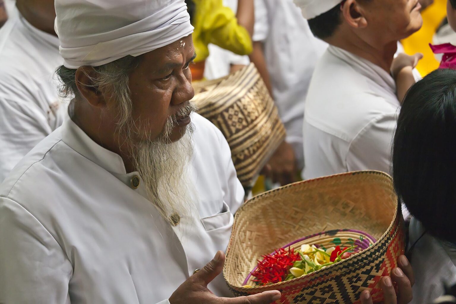 A BALINESE man brings offerings to PURA BEJI in the village of Mas during the GALUNGAN FESTIVAL - UBUD, BALI, INDONESIA