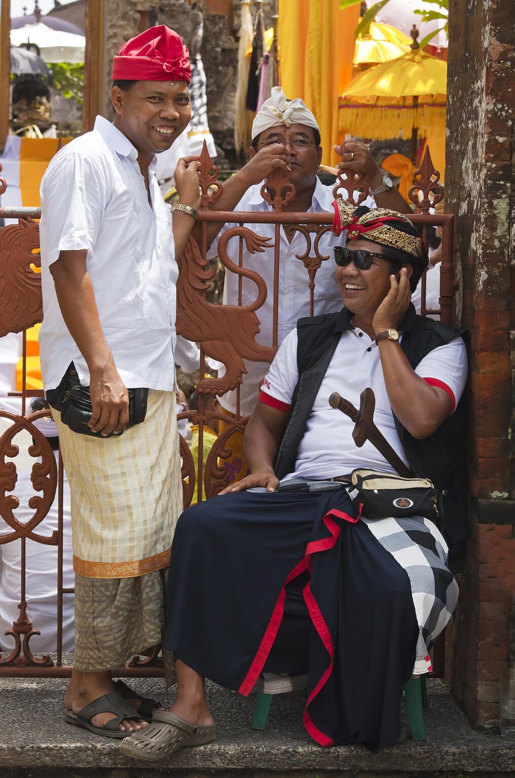 GAURDS joke around at the PURA BEJI in the village of Mas during the GALUNGAN FESTIVAL - UBUD, BALI, INDONESIA