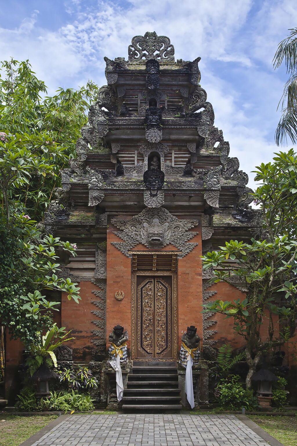 Ornate hand carved stone gate with Barong face of PURA DESA UBUD, the main Hindu temple of the town  - UBUD, BALI
