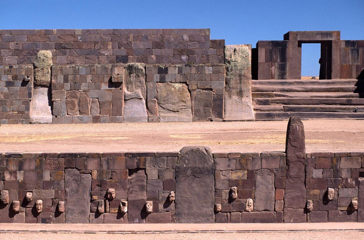 SEMI-UNDERGROUND TEMPLE & KALASSASAYA above with carved enemy heads - TIWANAKU (URBAN STAGE), BOLIVIA