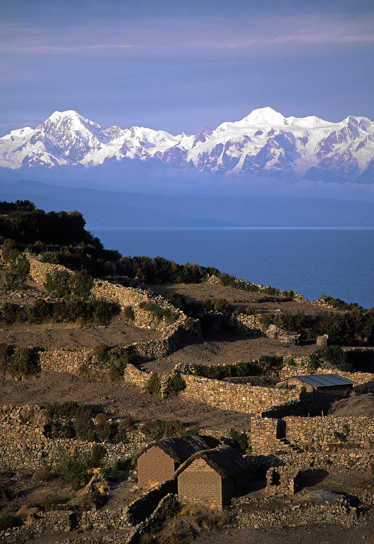 NEVADO ILLAMPU (7010 M) is visible behind the Village of CHALLAPAMPA on ISLE DEL SOL - LAKE TITICACA