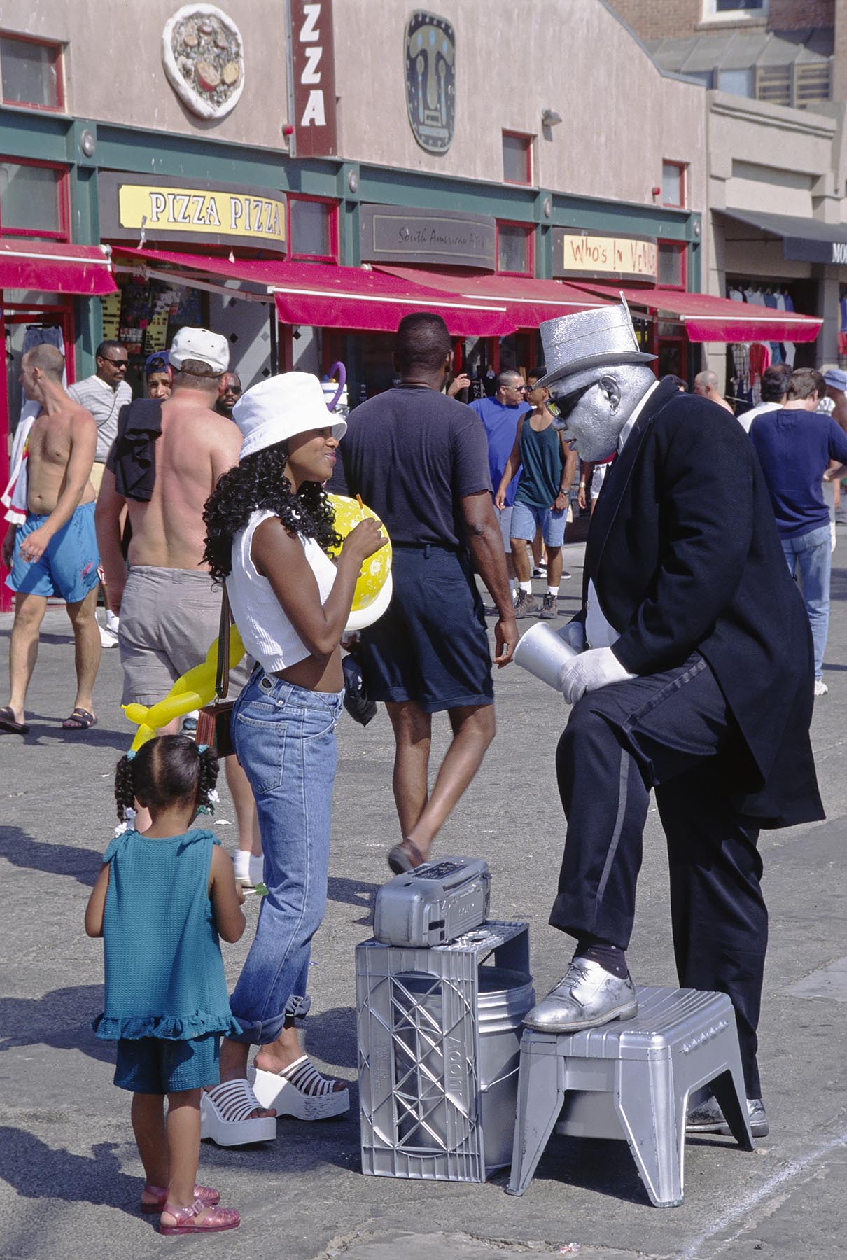 Entertainer talks with young African Americal woman  - VENICE BEACH, CALIFORNIA