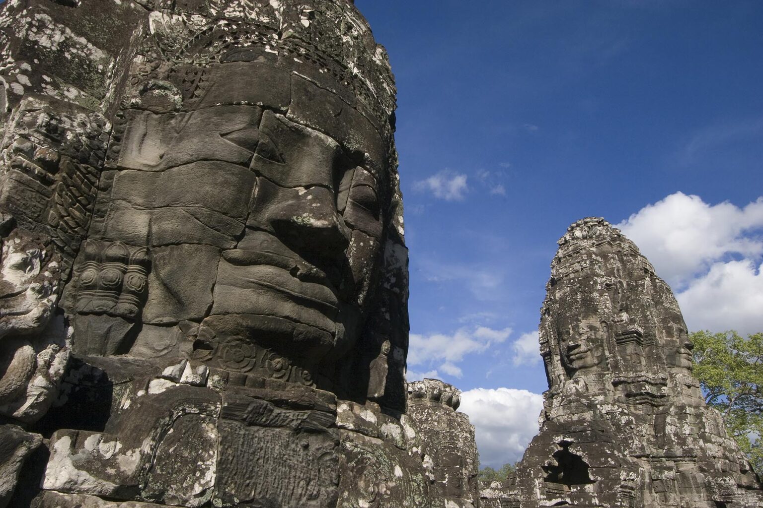 The face towers of The Bayon at Angkor Thom, the largest Khmer city ever built, are part of the Angkor Wat complex - Siem Reap, Cambodia