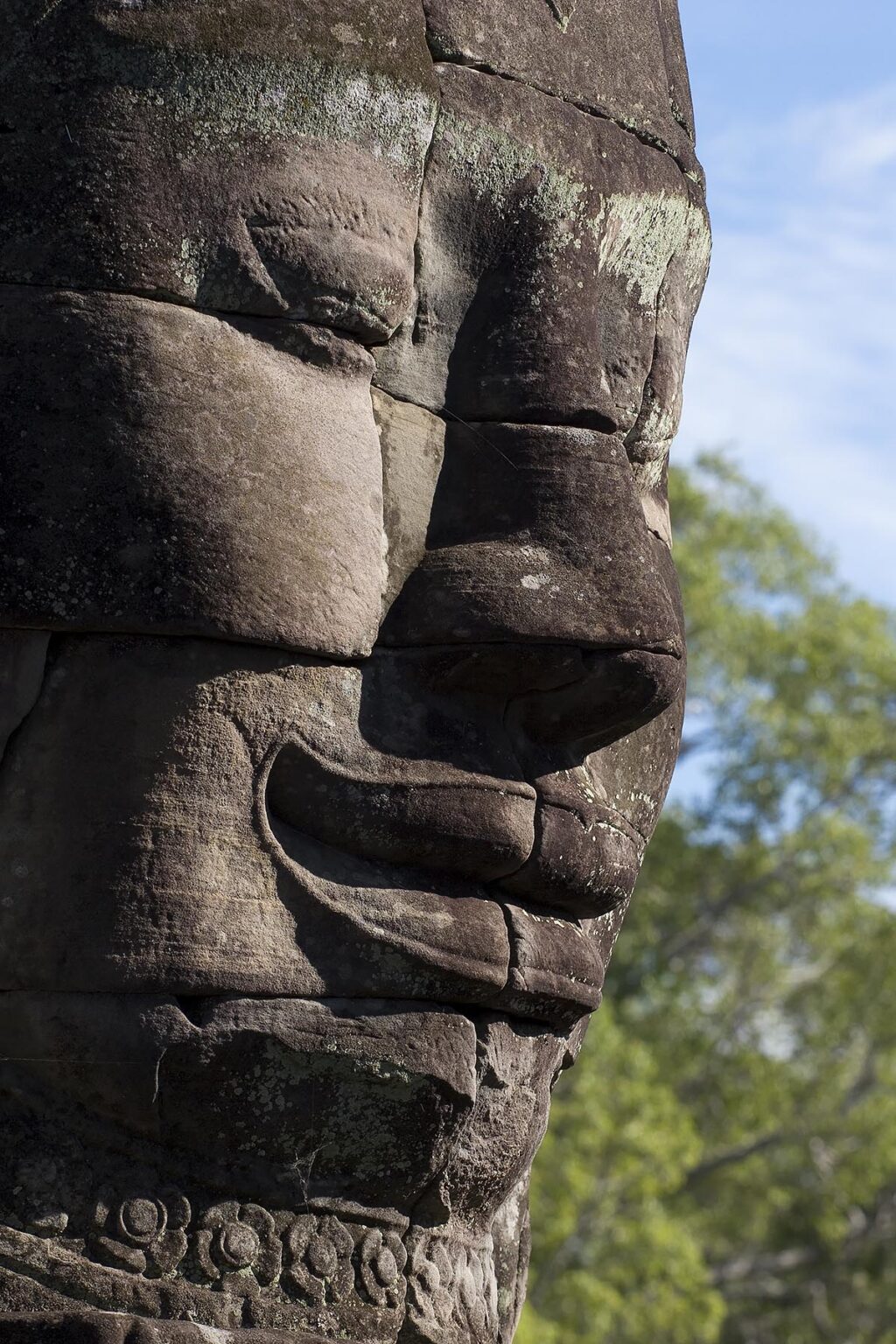 A close_up of a  face tower of The Bayon at Angkor Thom, the largest Khmer city ever built, are part of the Angkor Wat complex - Siem Reap, Cambodia