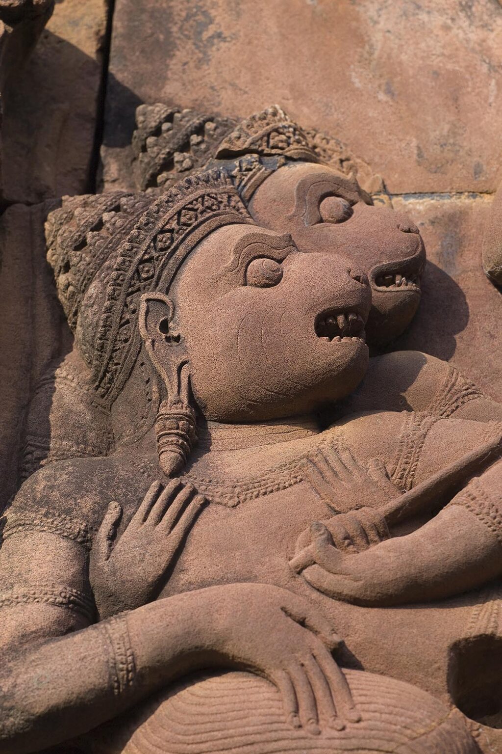 Bas relief detail in red sandstone of the W Pediment of the Gopura 1 W at Banteay Srei, 10th century Khmer architecture at Angkor Wat - Siem Reap, Cambodia