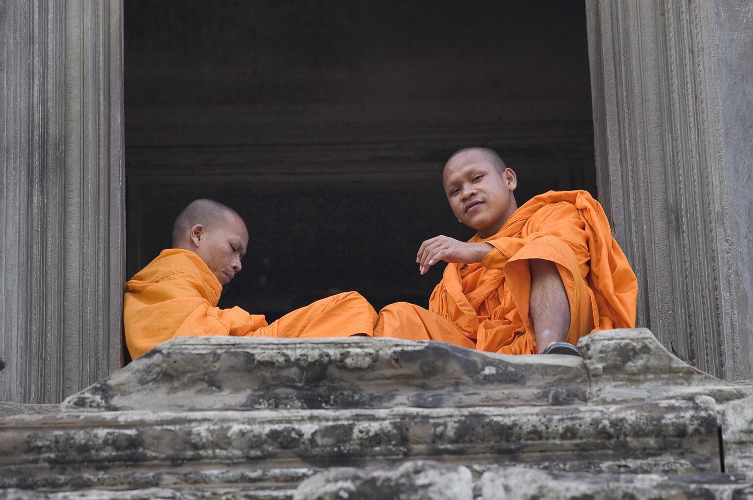 Cambodian Buddhist monks still worship at the ancient ruins of  Angkor Wat, built in the 11th century by Suryavarman the 2nd - Cambodia