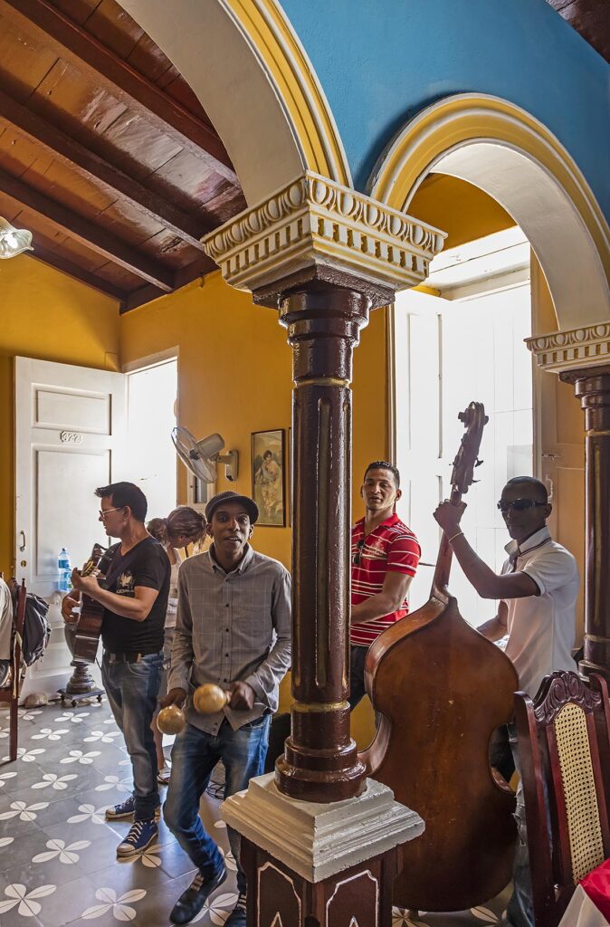 Musicians entertain tourists inside a restaurant - TRINIDAD, CUBA