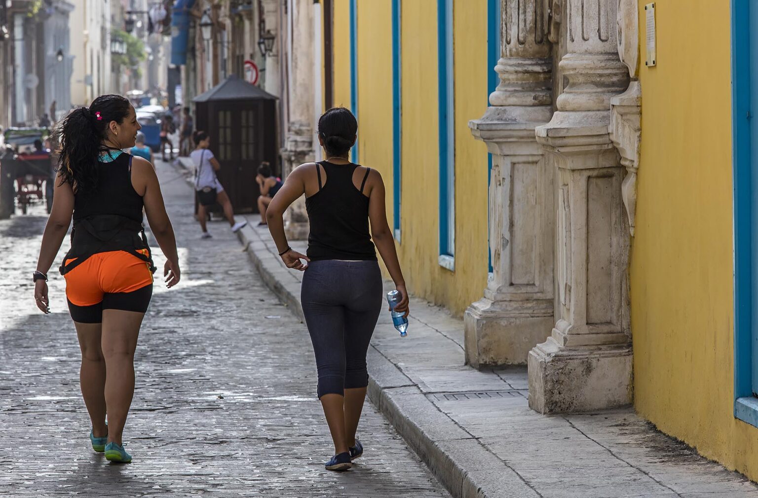Cuban woman walking in HABANA VIEJA - HAVANA CUBA