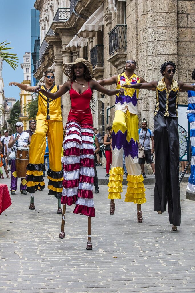STILT WALKERS entertain the crowd in the PLAZA DE ARMAS located in Habana Vieja - HAVANA, CUBA