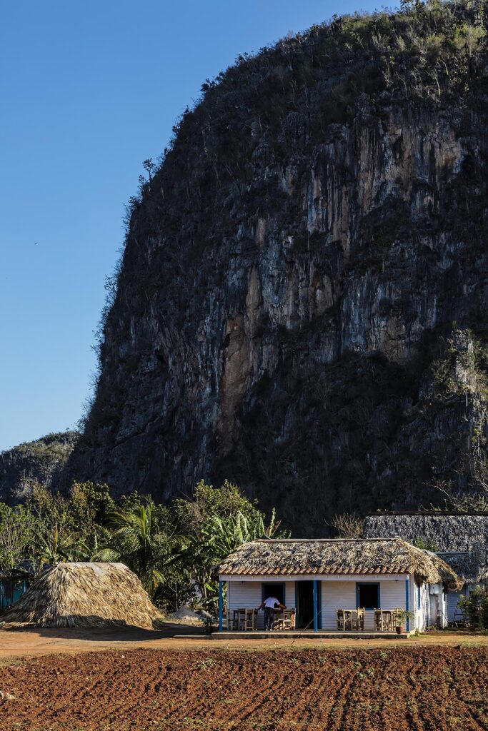 Karst formations tower above a restaurant near Vinales National Park - VINALES, PINAR DEL RIO, CUBA