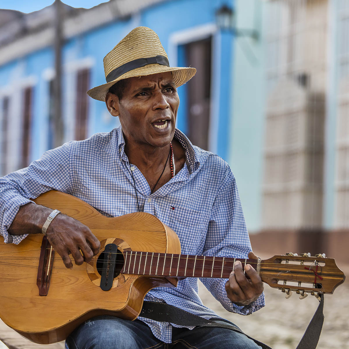 A CUBAN man plays traditional music on his guitar - TRINIDAD, CUBA