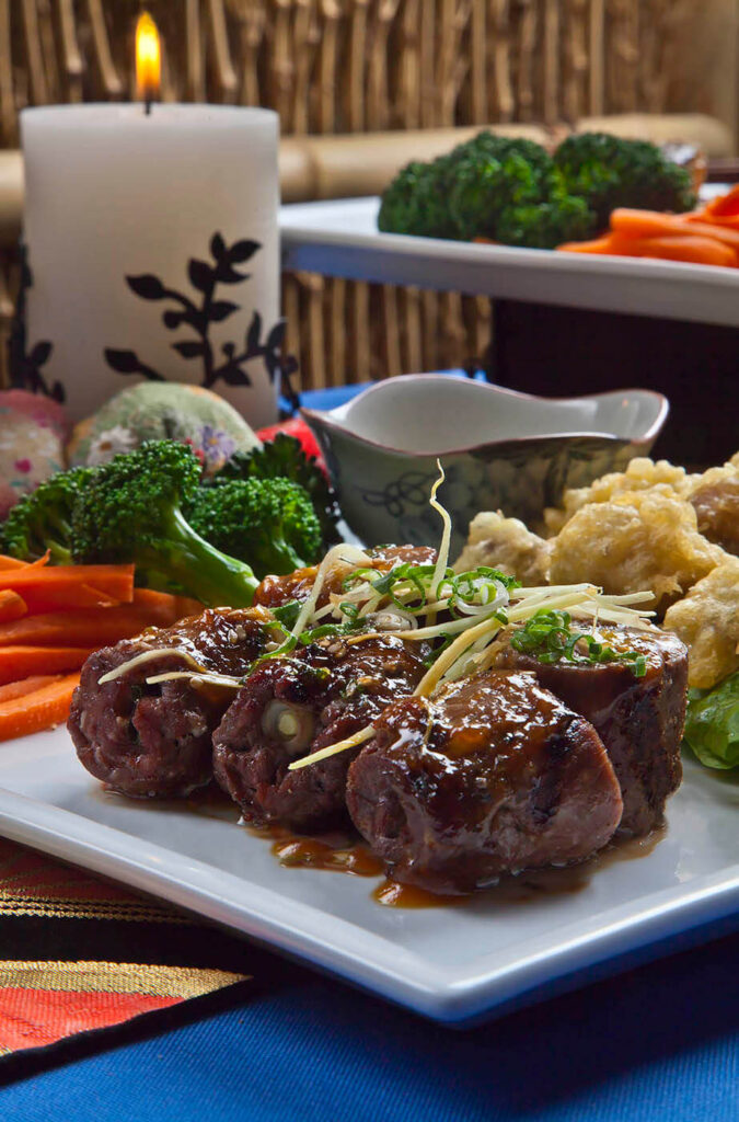Grilled filet mignon with ginger sauce & vegetables is served with shrimp tempura, broccoli and carrots at Robata Grill and Sushi in Carmel, California. Food photography by Craig Lovell.