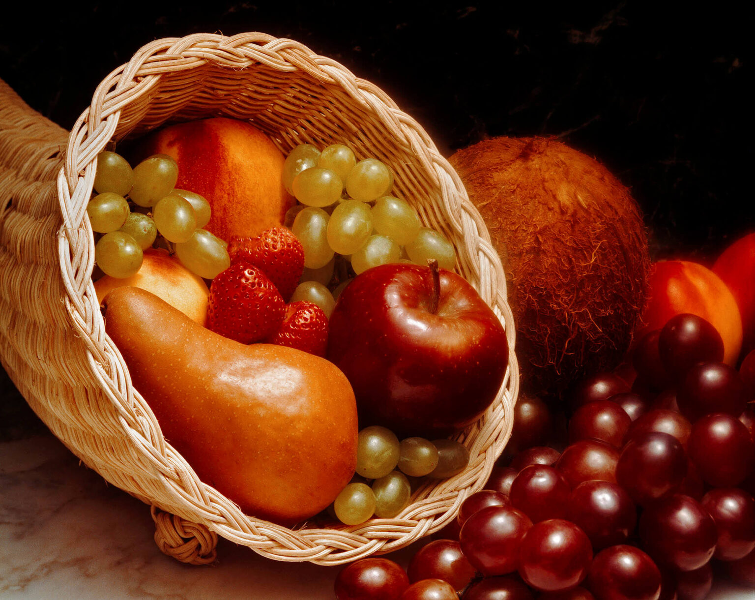 CORNUCOPIA of fresh fruit with grapes, pear, coconut, and nectorines