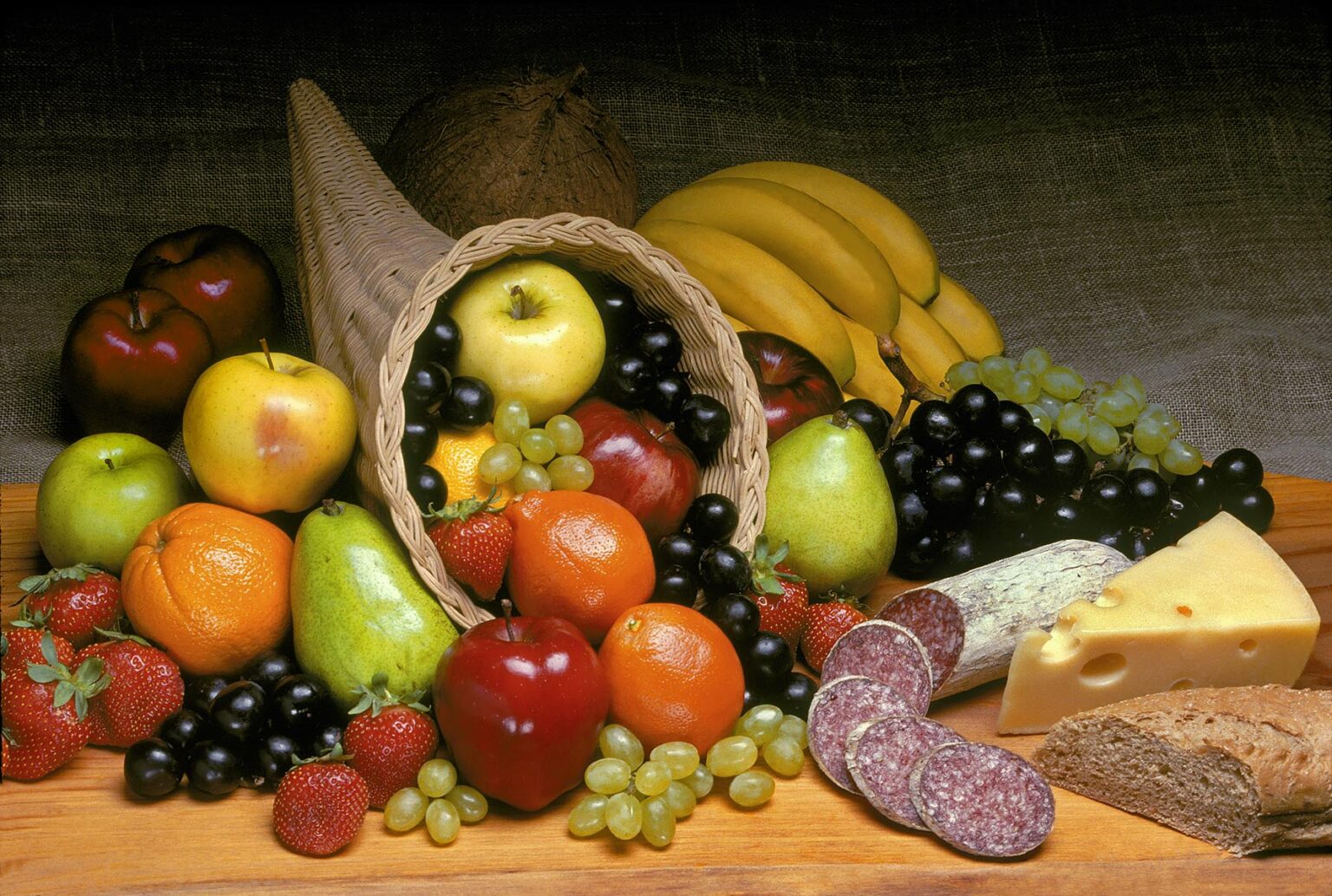 CORNUCOPIA of fruit with apple, pear, strawberries, bananas, oranges, tangelos and Italian salami, Swiss cheese and bread