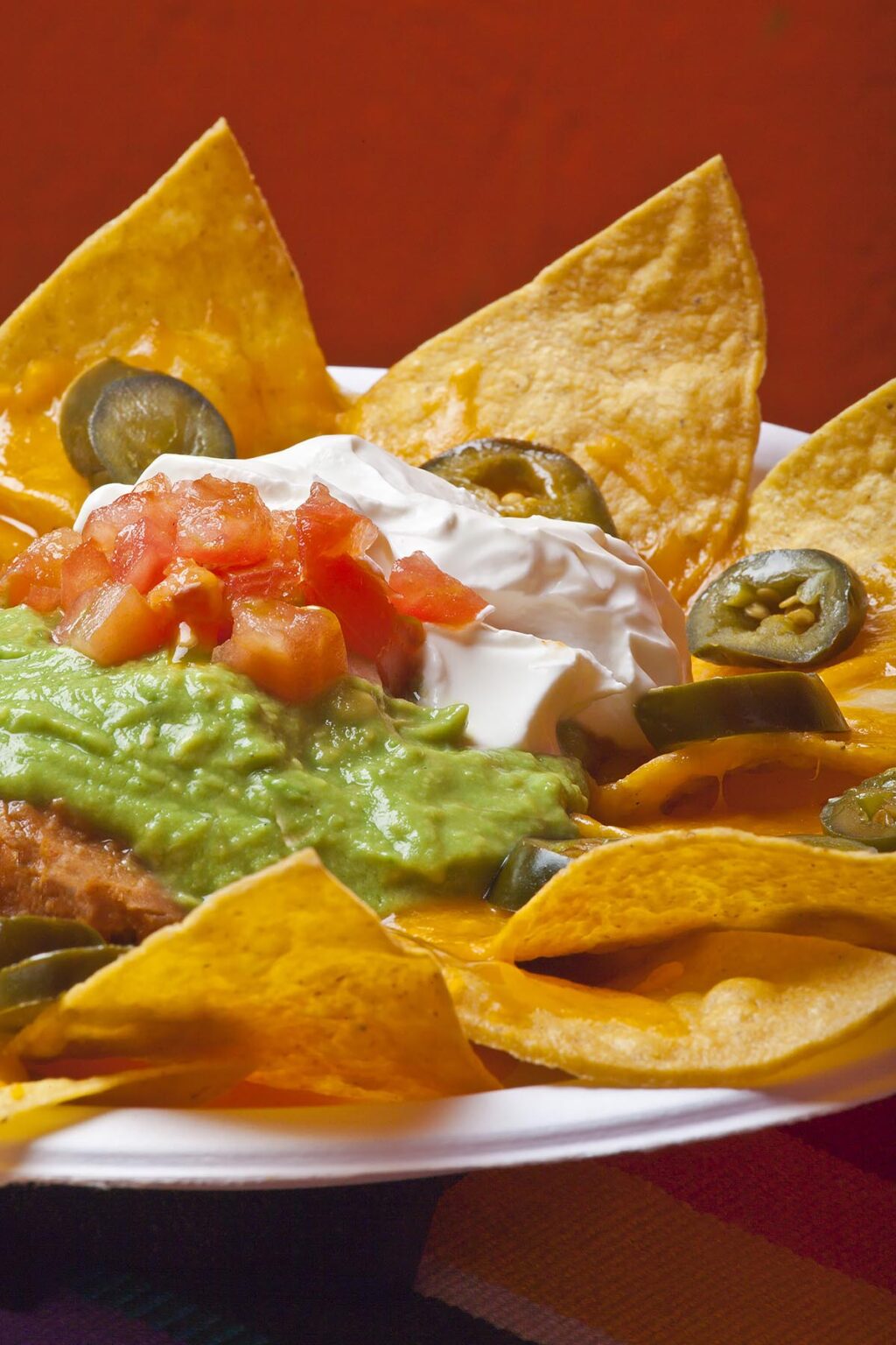 NACHOS with guacamole, sour cream and jalapeno peppers