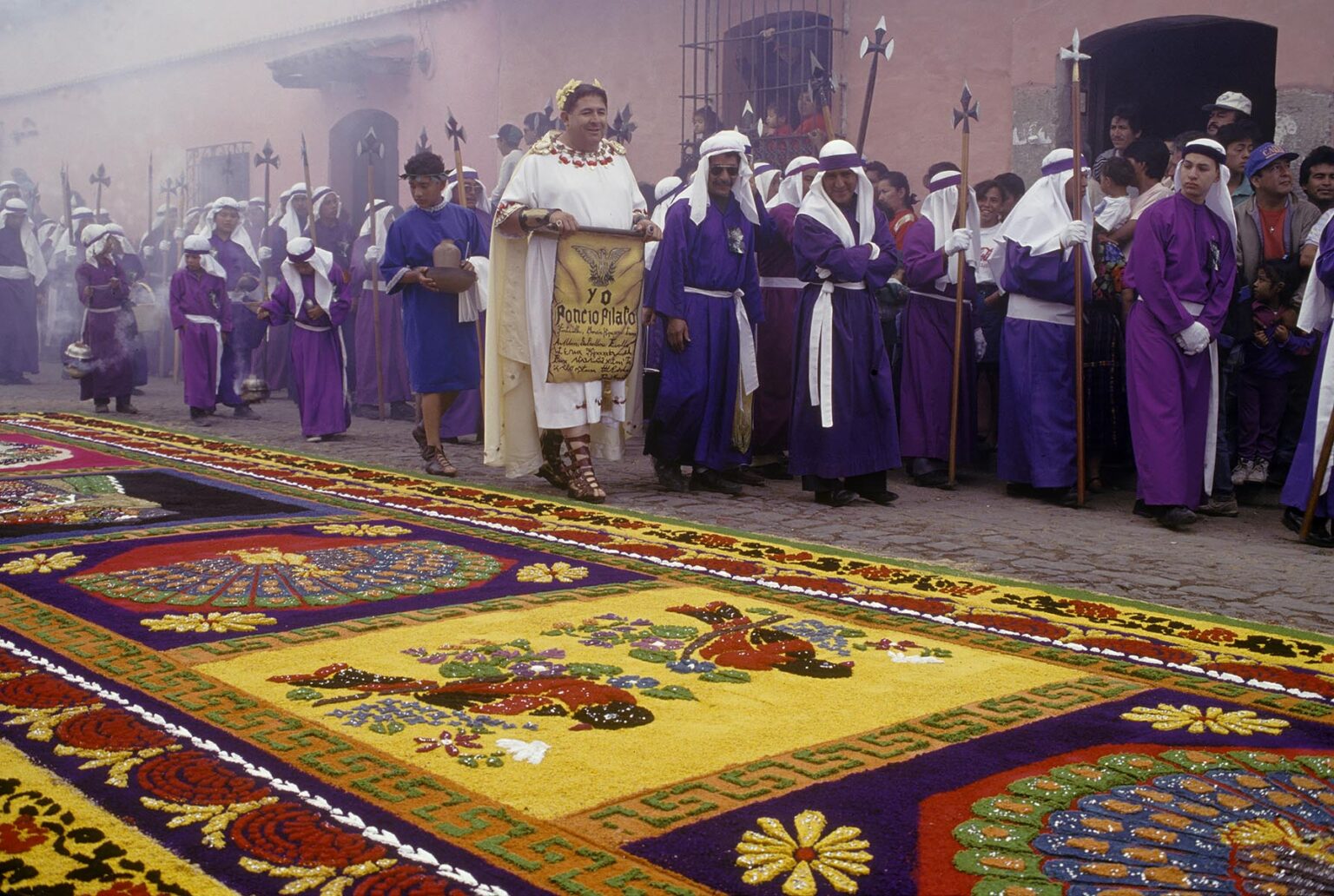 PENITENTS pass ALFOMBRA (carpet) with CATHOLIC symbolism and MAYAN imagery during GOOD FRIDAY - ANTIGUA, GUATEMALA