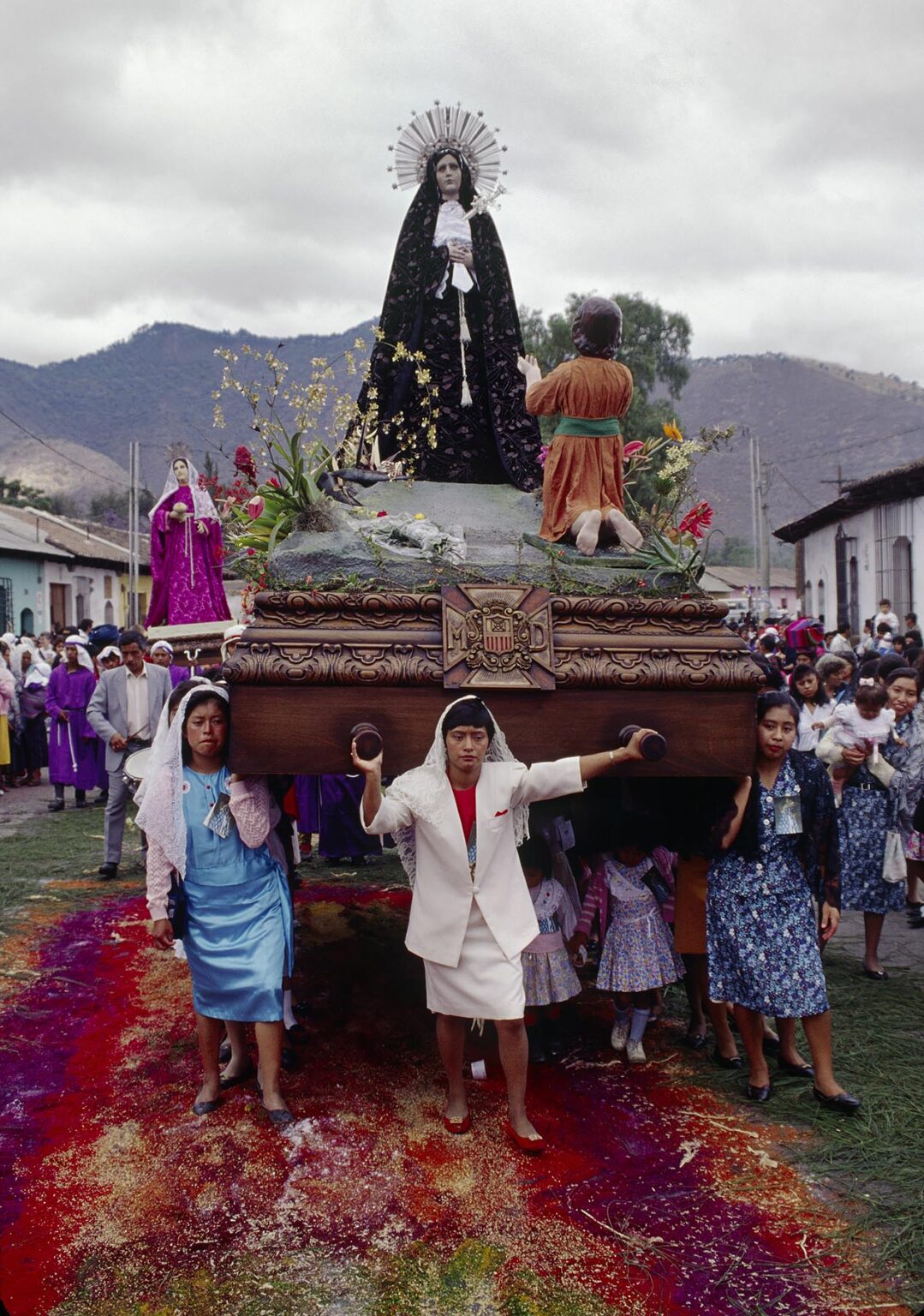 Women carry ANDA of the VIRGIN MARY (17th Century wooden statue) during GOOD FRIDAY PARADE - ANTIGUA, GUATEMALA
