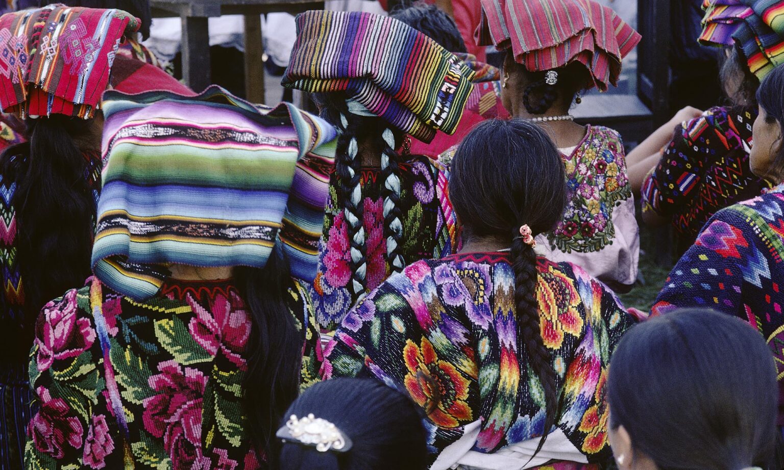GUATEMALAN WOMEN of MAYA descent wearing traditional HUIPILS - CHICHICASTENANGO, GUATEMALA