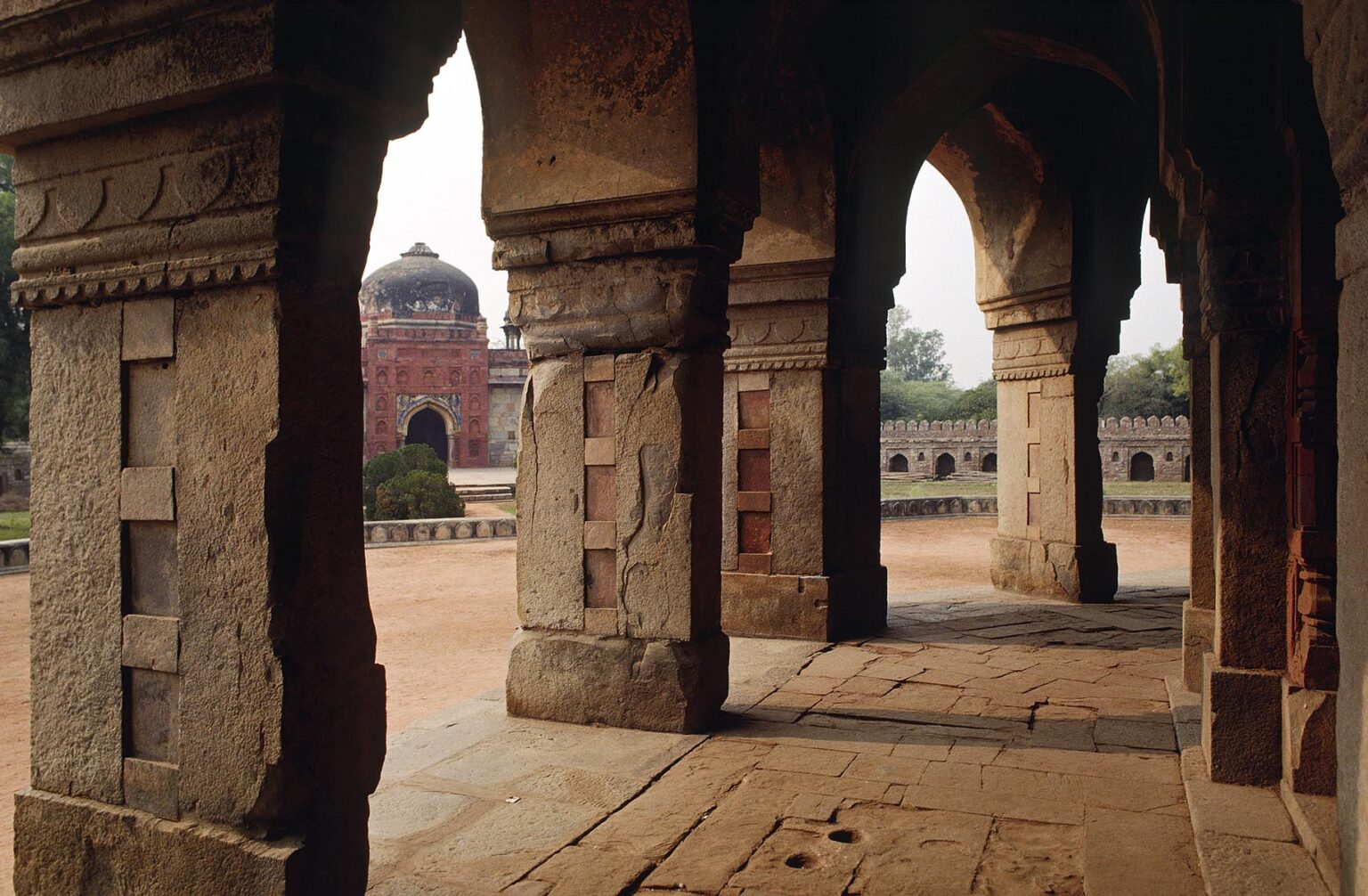ARCHES of Pathan (Afghan) design at ISA KHAN'S tomb in front of the Moghul designed HUMAYUN'S TOMB - DELHI, INDIA