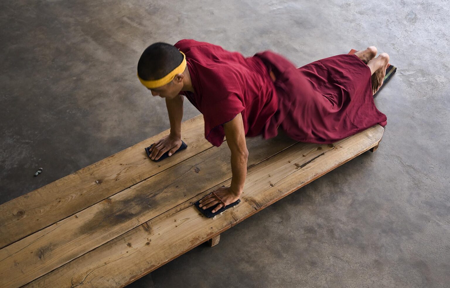 A TIBETAN MONK does prostrations at the NAMGYAL GOMPA or MONASTERY which is a GALUKPA SECT INSTITUTION of the 14th DALAI LAMA in MCLEOD GANG - DHARMSALA, INDIA