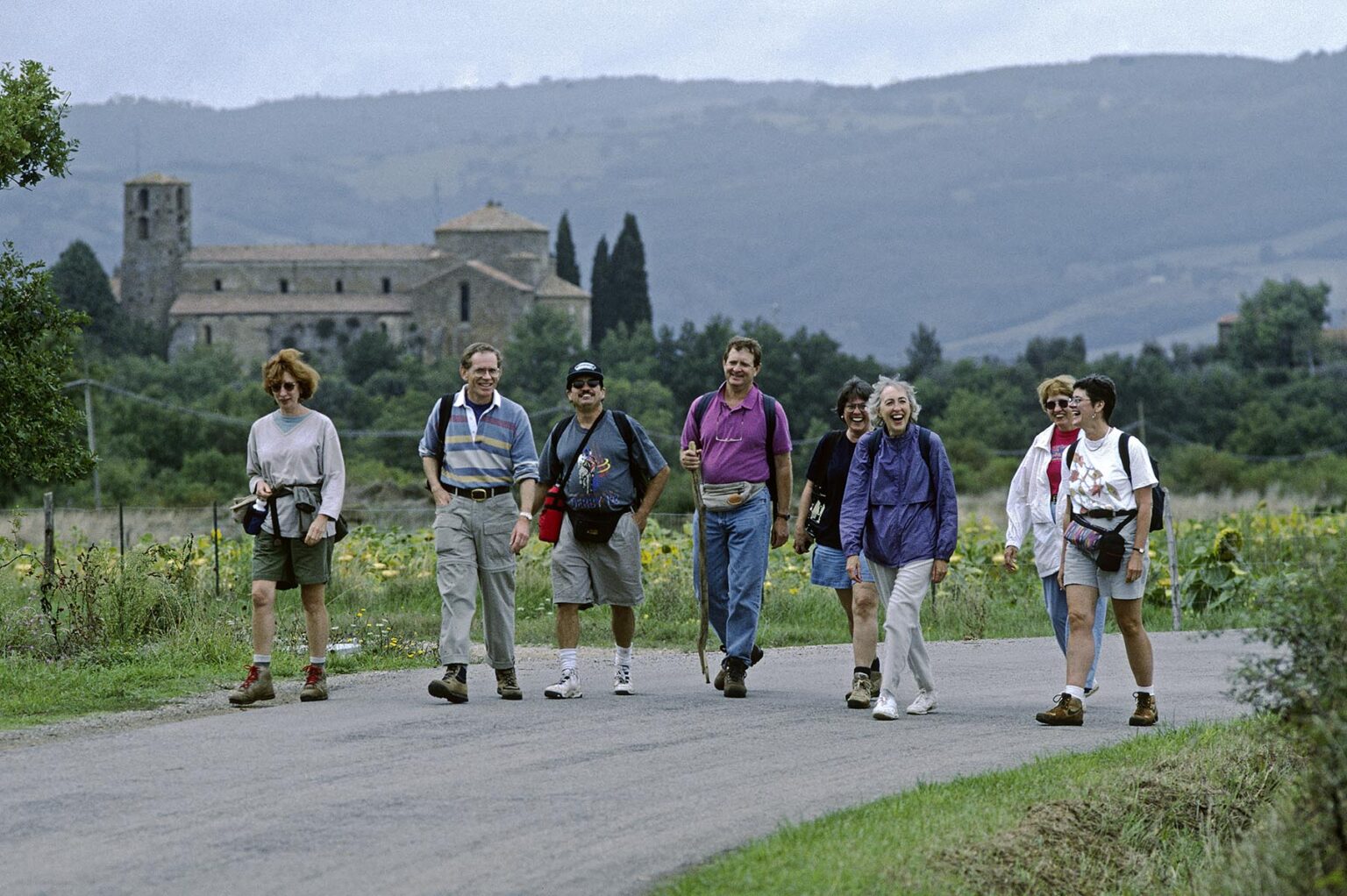 Hikers on a country road head for the town of SORANO - TUSCANY, ITALY