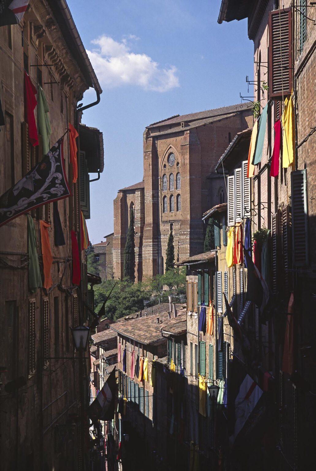 Flags decorate the buildings of Siena in preparation for a local festival - TUSCANY, ITALY