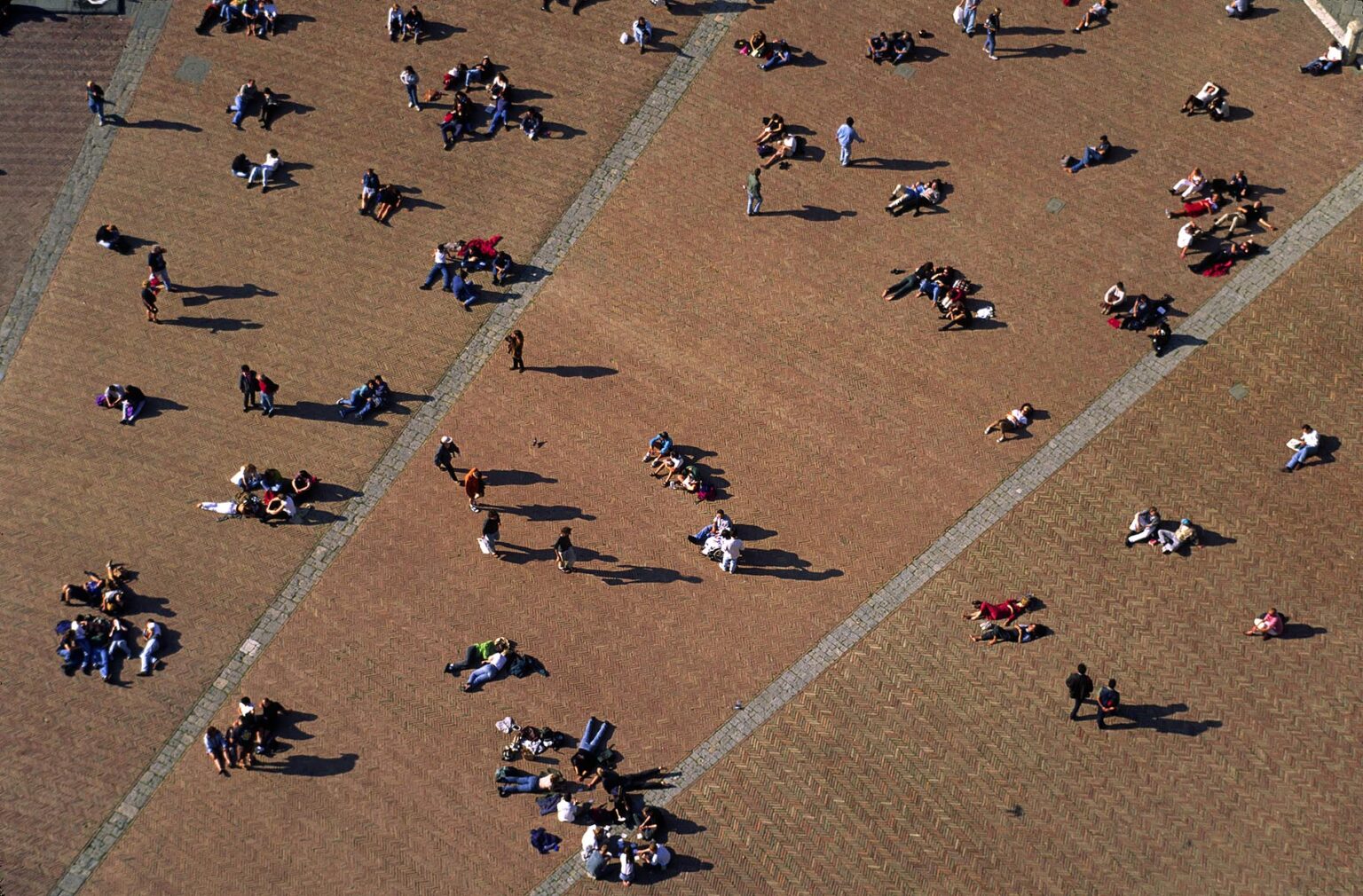People on the CAMPO (central plaza) as seen from the BELL TOWER in the MEDIEVAL city of SIENA - TUSCANY, ITALY
