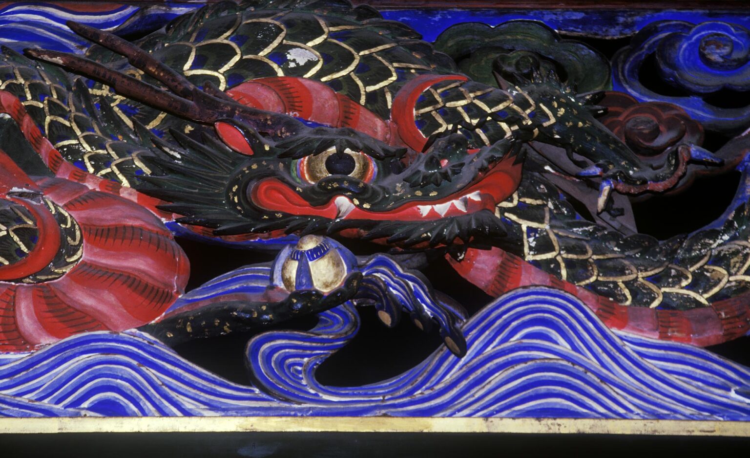 Carved and painted WOODEN DRAGON decorates the exterior of a BUDDHIST TEMPLE - KURASHIKI, JAPAN