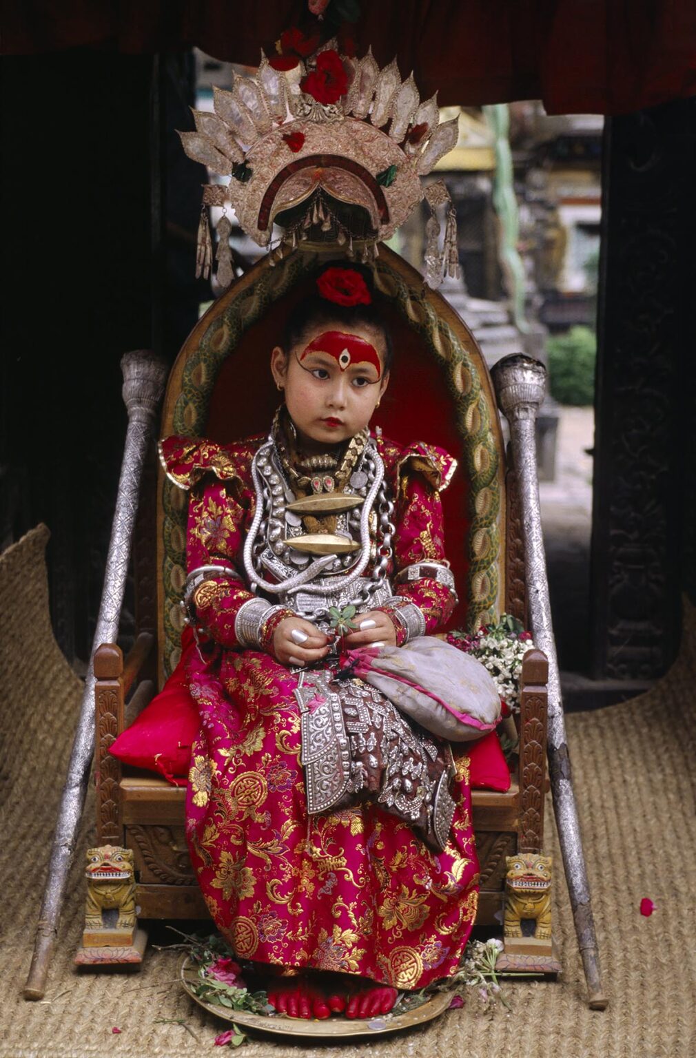 The LIVING GODDESS in her full regalia sits on her thrown during the Rato Machendranath Festival - PATTAN, NEPAL