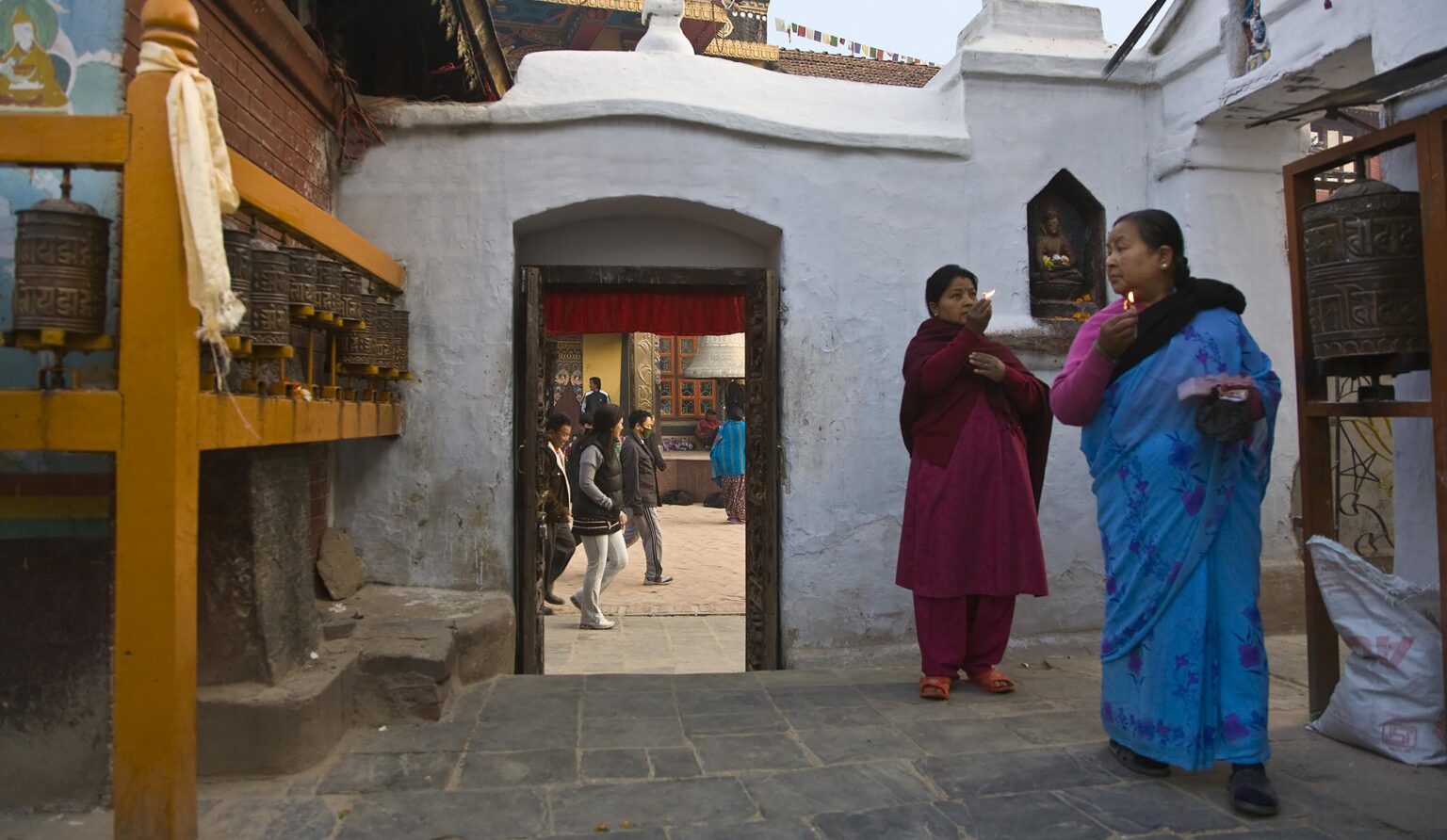 NEPALI WOMEN worship at BODHA STUPA - KATHAMANDU, NEPAL