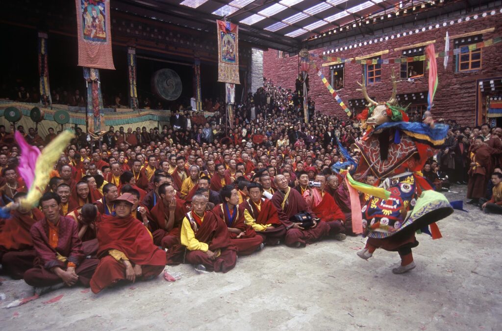 Masked stag dancer representing the animal world at the Monlam Chenmo, Katok Monastery - Kham, (Tibet), Sichuan, China