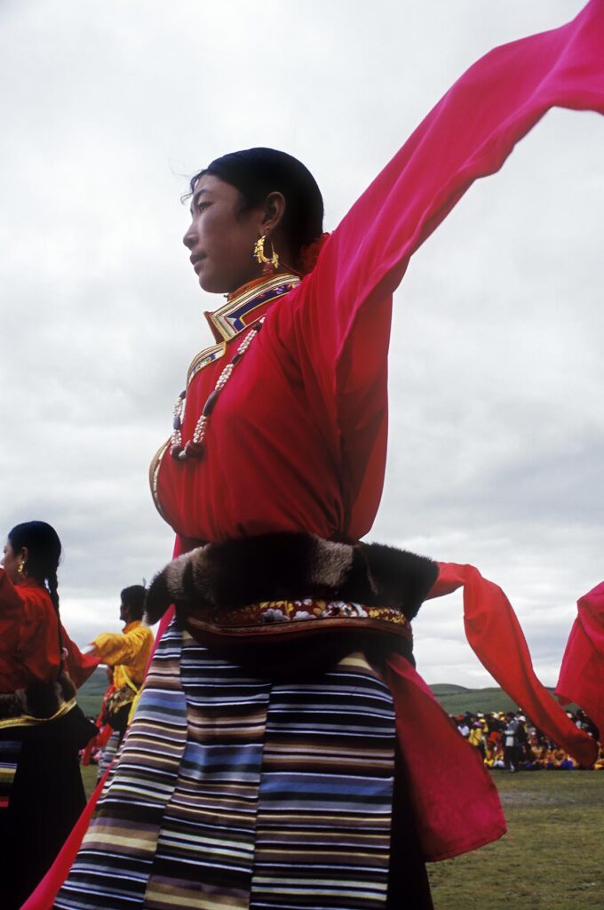 Dance troops preform at the Litang Horse Festival, representing various regions of Kham - Sichuan Province, China, (Tibet)