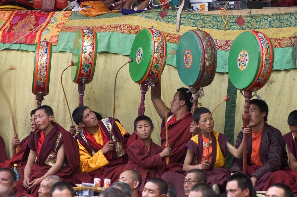 Nyingmapa monks play drums at the Monlam Chenmo dances, Katok Dorjeden Monastery - Kham, (Tibet), Sichuan, China