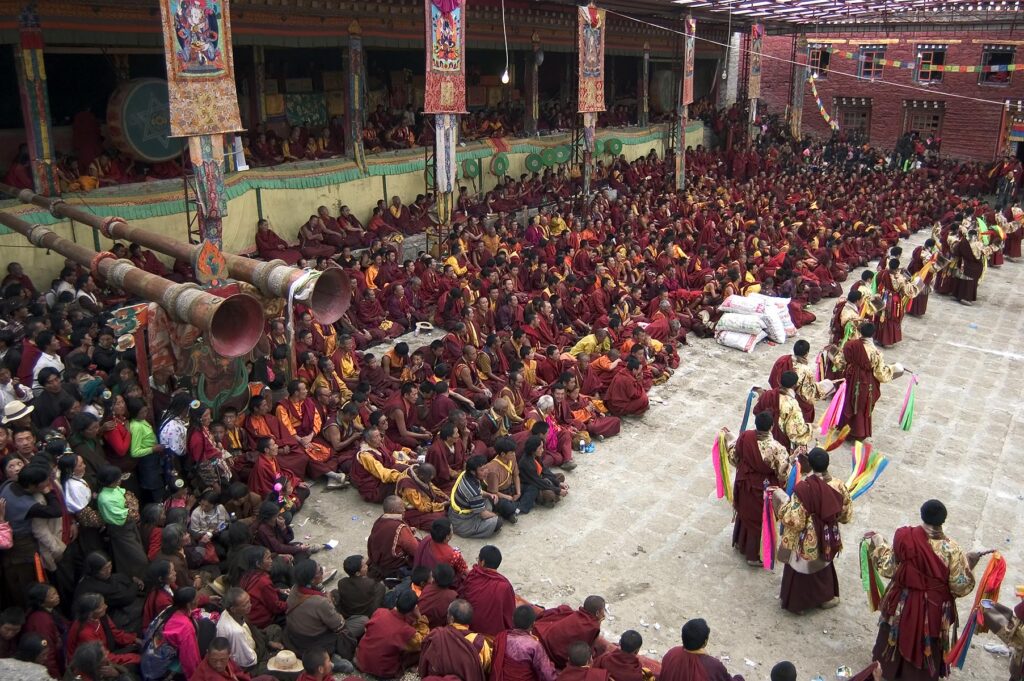 Monks dance with ribbons representing deity powers at the Monlam Chenmo, Katok Monastery - Kham, (Tibet), Sichuan, China