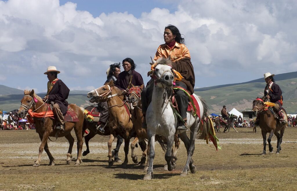 Khampas, the warrior horseman of old Tibet, compete at the Litang Horse Festival - Kham, Sichuan Province, China, (Tibet)