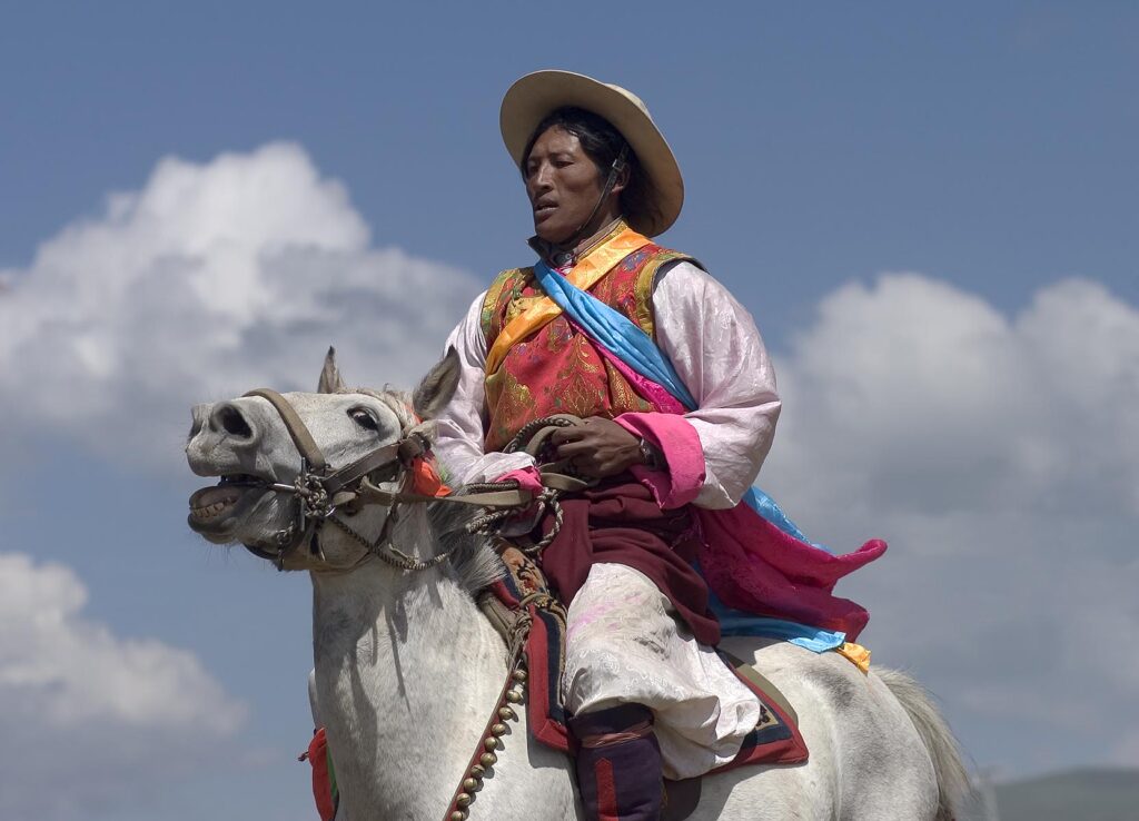 Khampas, the warrior horseman of old Tibet, compete at the Litang Horse Festival - Kham, Sichuan Province, China, (Tibet)