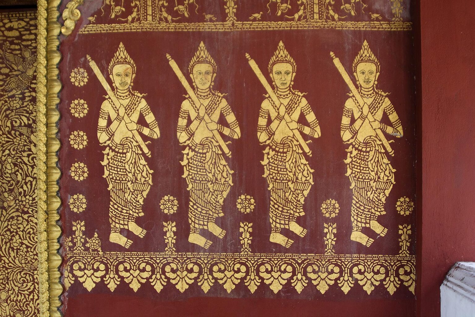 Four Buddhist deities are stenciled on the wall of Wat Si Bun Heuang in the former French Provincial town of LUANG PROBANG - LAOS