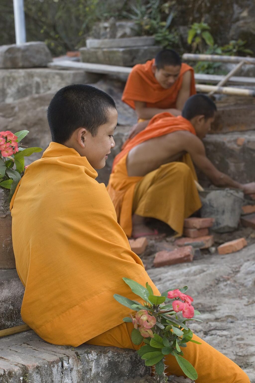 Young Hinayana Buddhist initiates at work in the former French Provincial town of LUANG PROBANG - LAOS