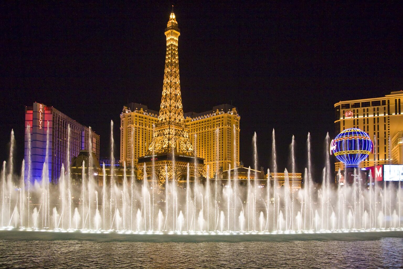 The evening FOUNTAIN SHOW at the BELLAGIO looking towards the PARIS HOTEL AND CASINO - LAS VEGAS, NEVADA