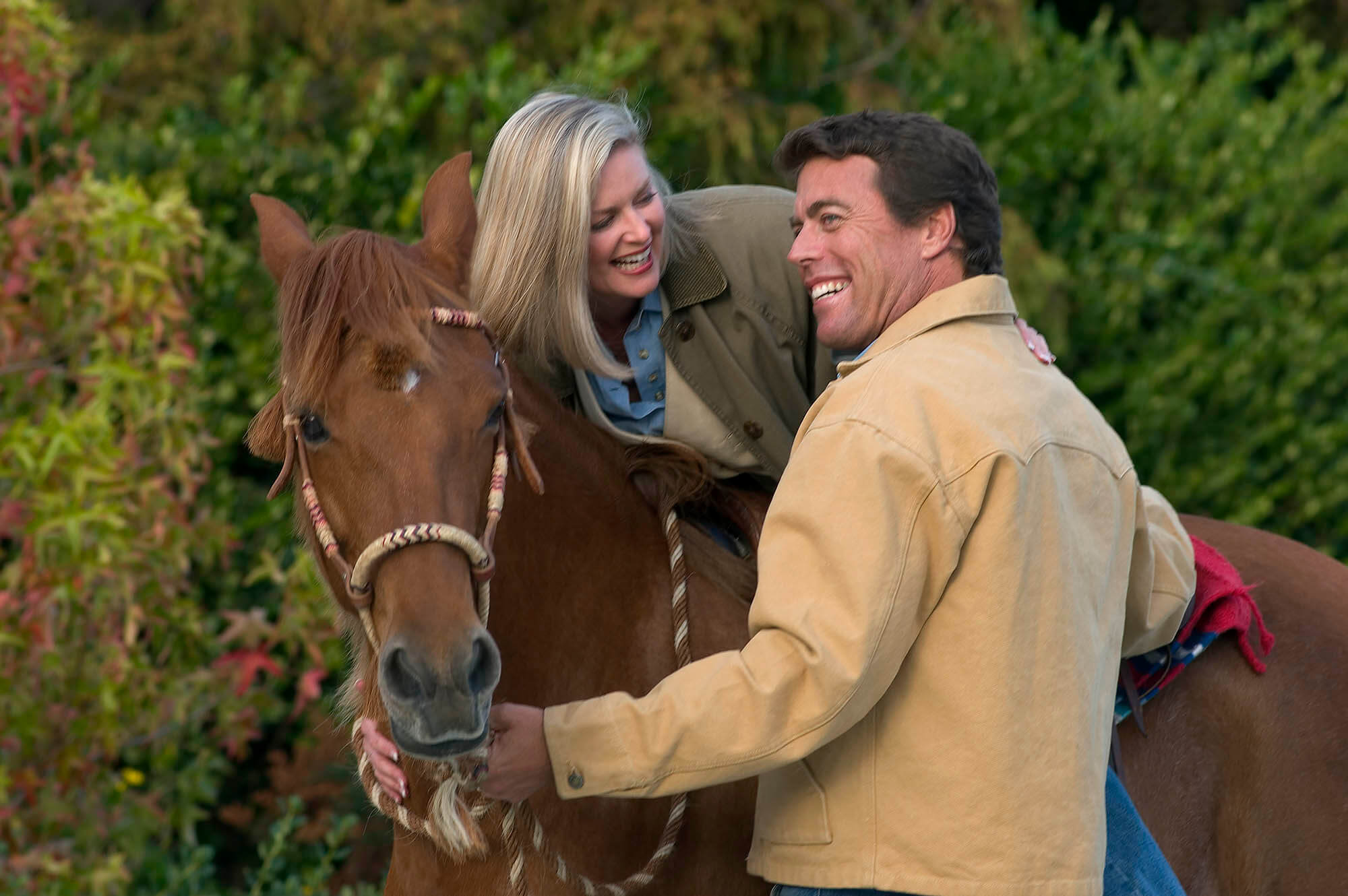 Lifestyle image of a couple enjoying a horse ride. Lifestyle photography by Craig Lovell