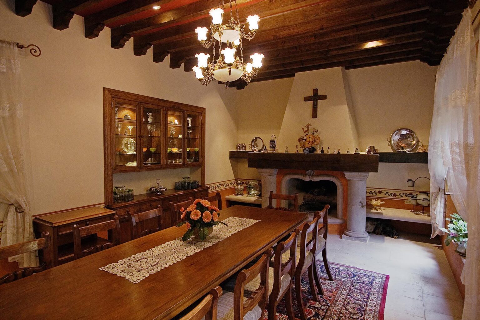 A wooden DINING ROOM TABLE and FIREPLACE in a house on the weekly HOUSE TOUR, SAN MIGUEL DE ALLENDE, MEXICO
