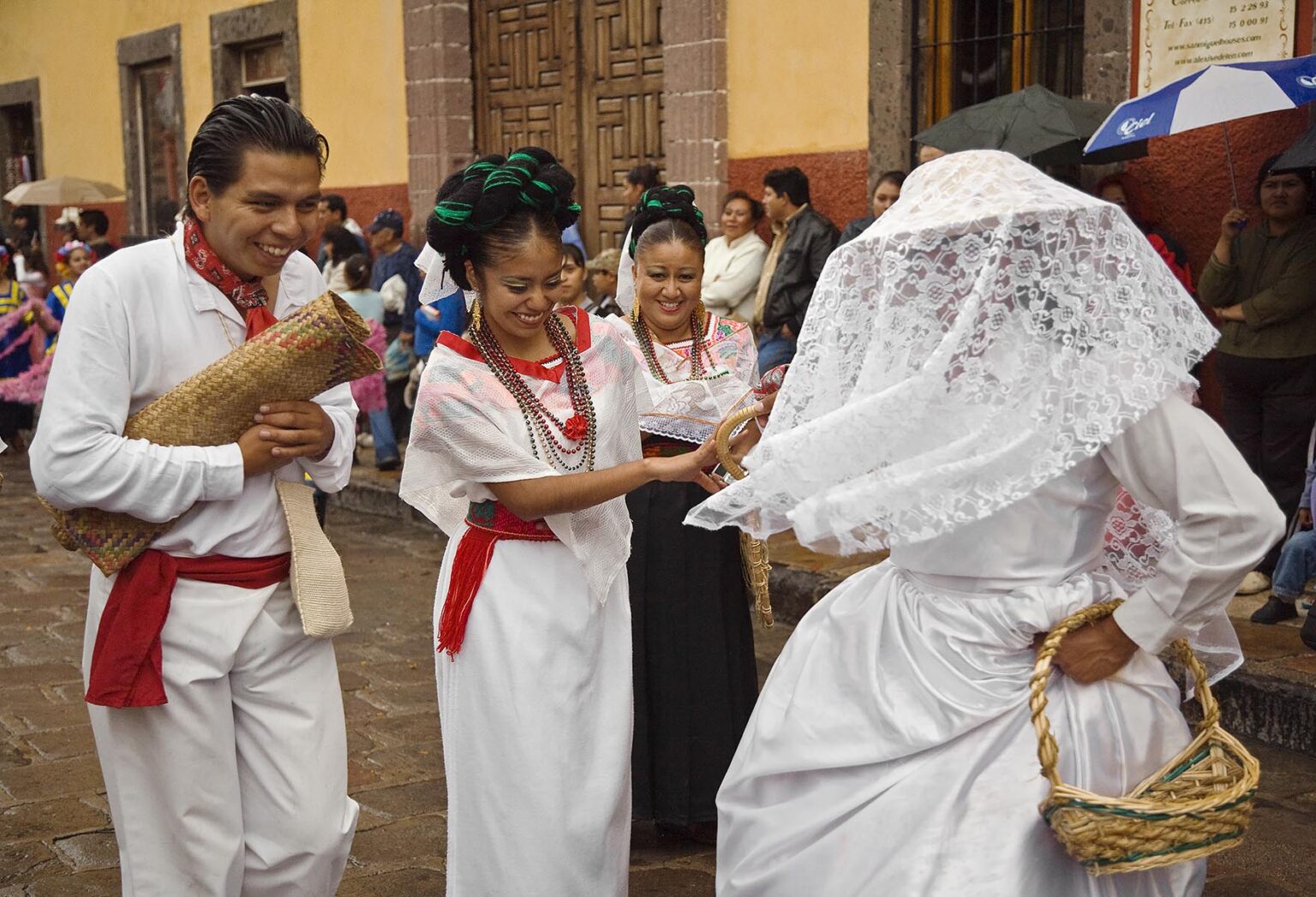 MEXICANS in traditional PEASANT COSTUME & WEDDING DRESS walk in the FESTIVAL DE SAN MIGUEL ARCHANGEL PARADE - SAN MIGUEL DE ALLENDE, MEXICO