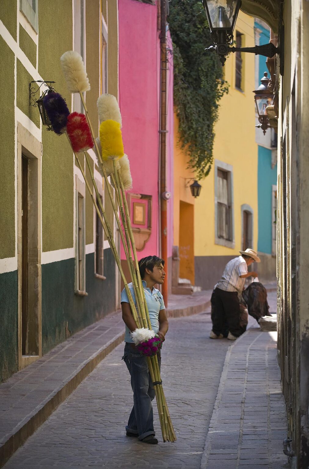 A street VENDOR sells DUSTERS door to door in the colorful and historic town of GUANAJUATO, MEXICO